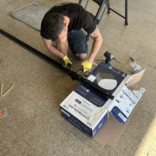 a carlos garage door technician working on a garage door opener